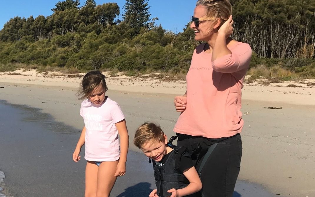 Woman and two kids on the beach