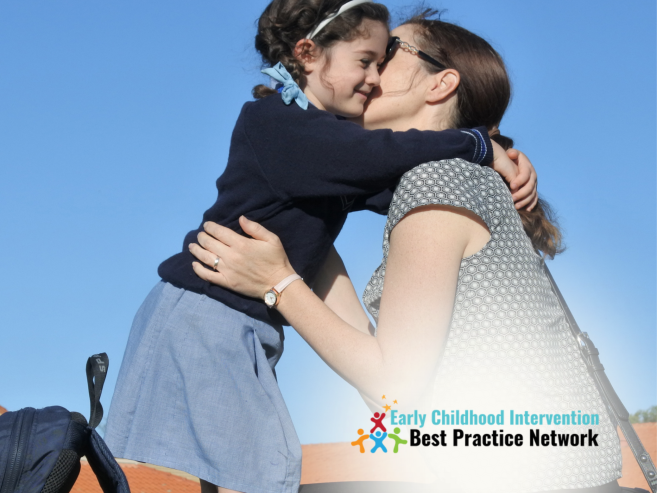 Mother bending down to hug daughter at school