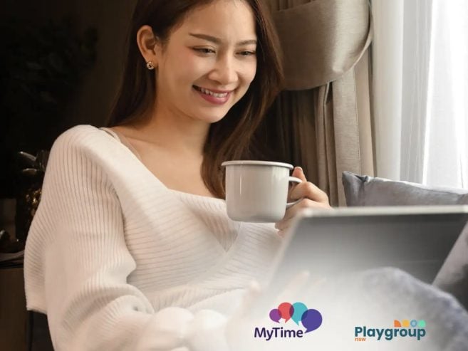 Woman sitting in front of laptop at home