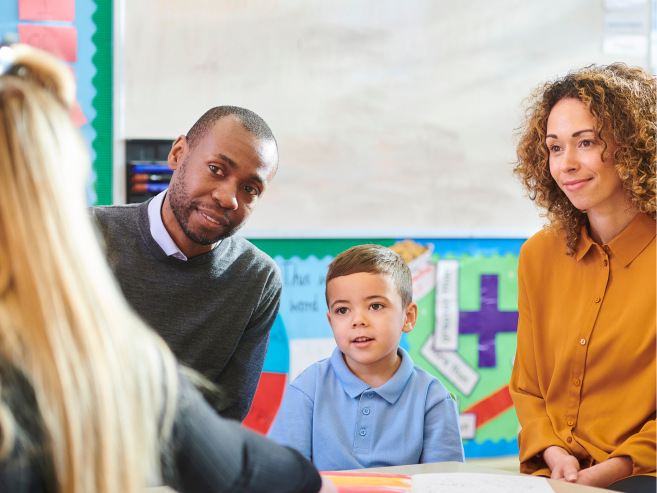 Two parents and child at school meeting