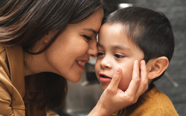 mother with her face against her autistic son
