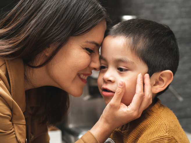 mother with her face against her autistic son