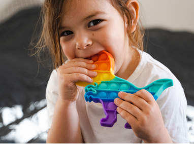 Young child with sensory chewy in their mouth