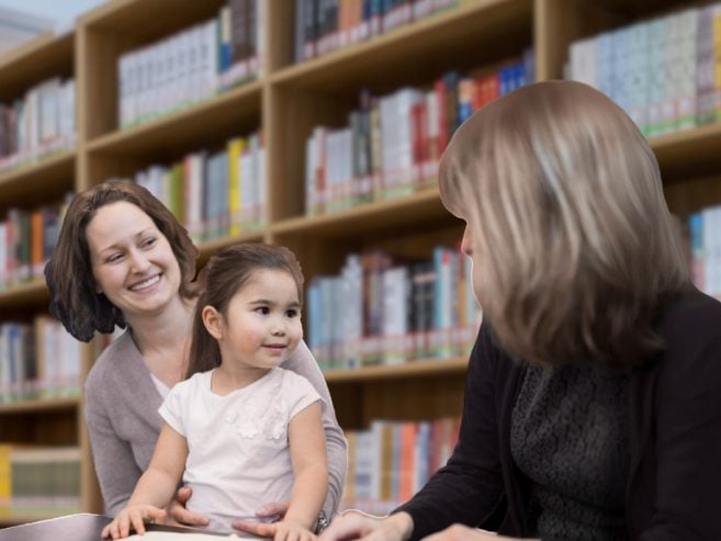 Mother and child talking to a teacher