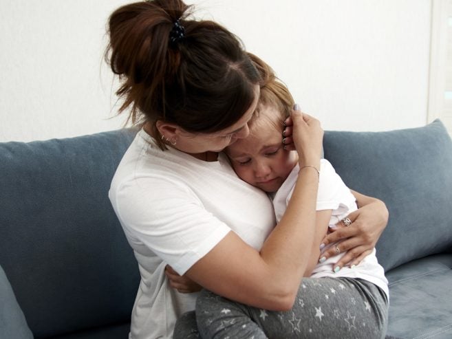 Mother hugging daughter
