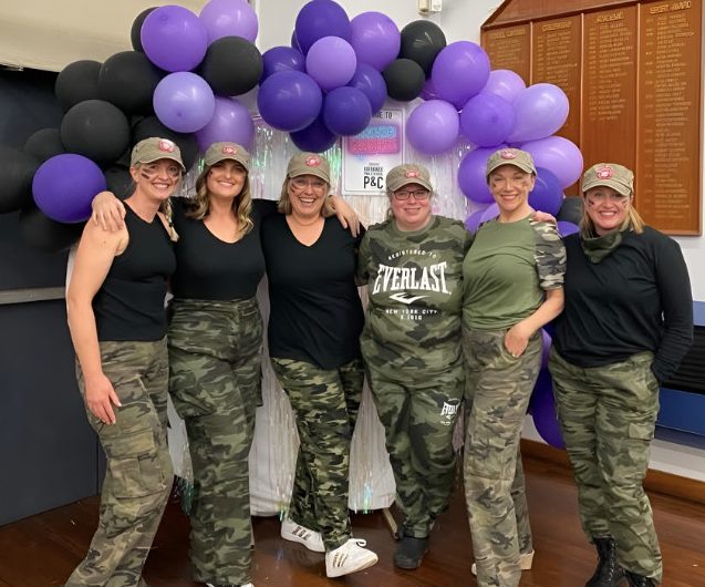 Group of mums standing together at a school fundraiser